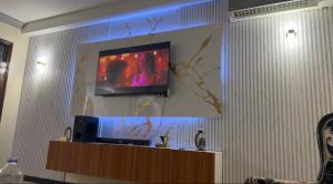 a flat screen tv hanging on a wall at Ahfash Homes in Mombasa
