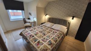 a bedroom with a bed with a quilt on it at Kose apartment in Kose