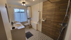 a bathroom with a sink and a toilet and a shower at Kose apartment in Kose +15 photos