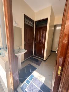 a bathroom with a sink and a mirror at Ahfash Homes in Mombasa