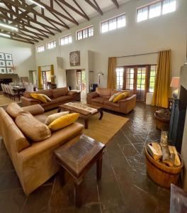 a large living room with couches and tables at Luxury Country Retreat Hot Tub & Farm Views in Dullstroom