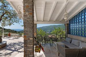 an outdoor patio with a couch and a table at Appartamento Villa Antonia in Marina di Andora