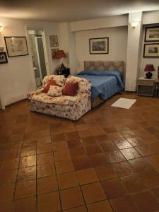 a bedroom with a bed and a couch at villa marta in Formia +22 photos