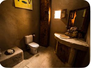a bathroom with a toilet and a sink and a mirror at Siwa Villa in Siwa +33 photos