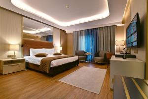 a hotel room with a bed and a television at Petra Moon Luxury Hotel in Wadi Musa +37 photos