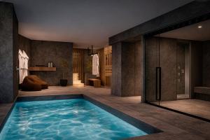 a bathroom with a large swimming pool in a room at Hotel Himàlaia Soldeu by Nexta in Soldeu