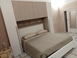 a bedroom with a bed with two pillows on it at Residenza Delizia in Gallipoli