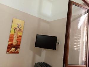 a flat screen tv hanging on a wall at Residenza Delizia in Gallipoli