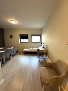 a room with a bed and a desk and a chair at Torghatten Lodge in Torget