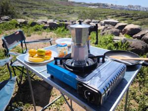 a blender on a table with a plate of fruit at Tenerife Camper Van Teide Surf and Beaches Sleeps 2 in San Miguel de Abona