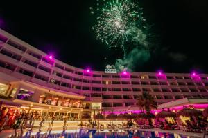a hotel with a fireworks display in the background at ON Hotels Oceanfront Adults Designed in Matalascañas +69 photos