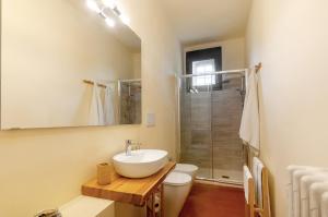 a bathroom with a sink and a toilet and a shower at Felciolina - Medieval Country House in Troghi +22 photos