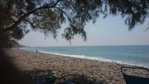 a view of a beach with people in the water at Xenos Apartments in Keratokampos