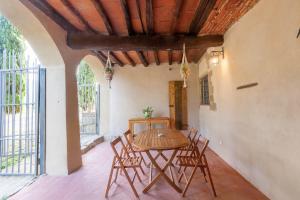 a dining room with a table and chairs at Felciolina - Medieval Country House in Troghi