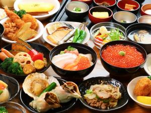 a table topped with bowls of different types of food at Dormy Inn Premium Sapporo in Sapporo