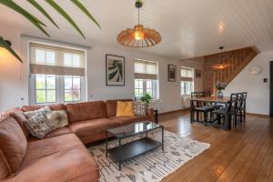 a living room with a couch and a table at Amazing villa for 8 in Bredene in Bredene