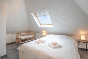 a bedroom with a bed with two candles on it at Amazing villa for 8 in Bredene in Bredene