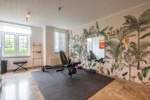 a room with a gym with plants on the wall at Amazing villa for 8 in Bredene in Bredene
