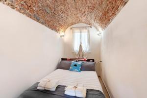 a small bedroom with a bed and a window at La Volta Segreta in Albenga