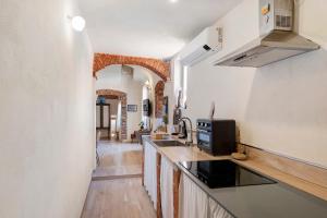 a kitchen with a sink and a counter top at La Volta Segreta in Albenga