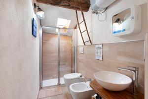 a bathroom with a sink and a toilet and a shower at La Volta Segreta in Albenga +13 photos