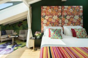 a bedroom with a bed with a floral headboard at Speronari Suites in Milan