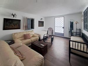 a living room with a couch and a chair at Olive Mill Complex in Livadi