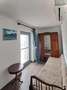 a bedroom with a bed and a table and a window at Olive Mill Complex in Livadi