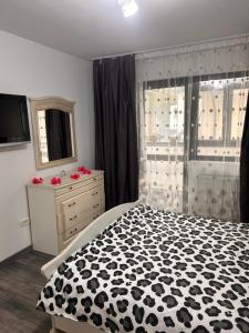 a bedroom with a black and white bed and a window at D&D New Residence in Piteşti
