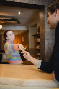 a man and a woman standing at a table eating food at Hotel Alpenblick in Saalbach-Hinterglemm +44 photos