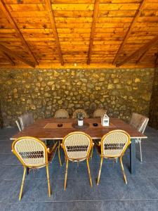 a wooden table with chairs and a wooden ceiling at Vega House Luxury & Relax in Orşova