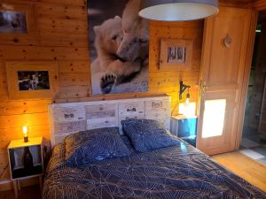 a bedroom with a bed and a picture of teddy bears at Chalet Les Vosgiennes in Le Valtin
