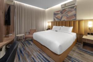 a bedroom with a large bed and a living room at فندق لفيف العريض - Lafeef Hotel Al-Aridh in Medina