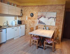 a kitchen with a wooden table in a room at Ferienwohnung Rieder in Wörgl