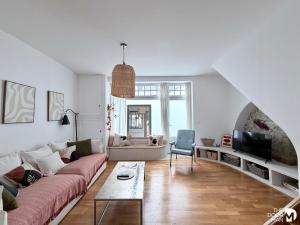 a living room with a couch and a table at Maison du Caboteur de La Baule, Centre & plage à pied, Patio cosy, 8 pers in Le Pouliguen