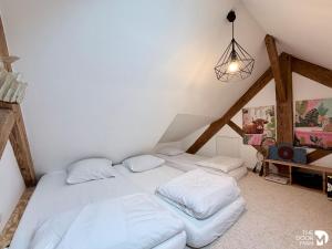 a bedroom with two beds in a attic at Maison du Caboteur de La Baule, Centre & plage à pied, Patio cosy, 8 pers in Le Pouliguen