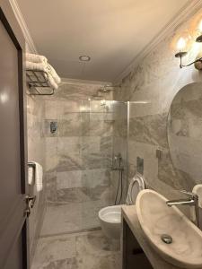 a bathroom with a sink and a toilet and a shower at The Pilgrim Ephesus Hotel in Selçuk