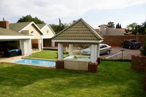 a gazebo with a pool in a yard at Jolani Guest House in Welkom