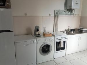 a kitchen with a washing machine and a sink at Appartement de cachet de 63m2 in Moulins