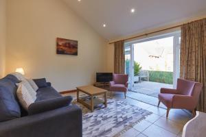 a living room with a couch and two chairs at Lordington Park in Chichester