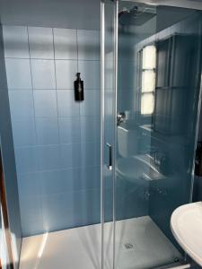 a glass shower in a bathroom with a sink at Locanda Orticello in Monferrato in Cremolino