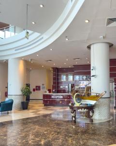 a lobby with a museum with a boat on a table at Plaza Inn Hotel in Doha