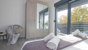a bedroom with a bed and a large window at Villa Dani by Villas Guide in Gostinjac