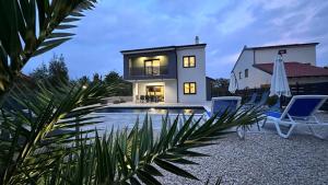 a villa with a swimming pool and a house at Villa Dani by Villas Guide in Gostinjac
