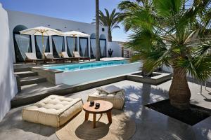 a patio with a pool and a table and a couch at Casa Alisios Sea View Villa private Infinity Pool Sunsets in La Pared