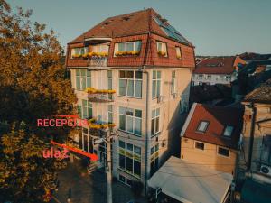 a tall building with a red roof at Apartman 4B H Pozarevac in Požarevac
