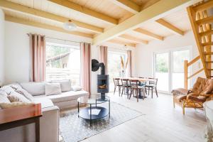 a living room with a couch and a table at Murawki Dom Blisko Jeziora in Urowo