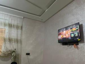 a flat screen tv hanging on a wall at Rachid in Oulad Akkou