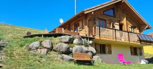 a log house with a bench in front of it at Chalet Les Vosgiennes in Le Valtin