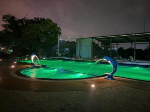 a swimming pool at night with green lights at The Palm Tree Bungalow in Xuân Sơn +13 photos